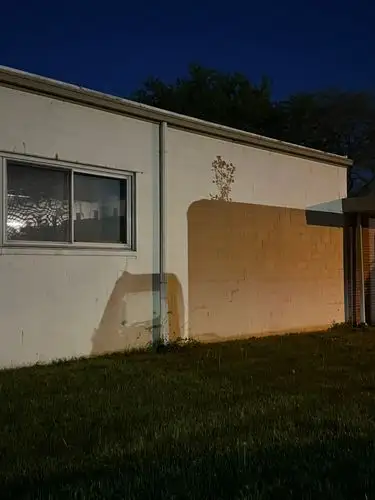 Night's quiet embrace on worn walls.